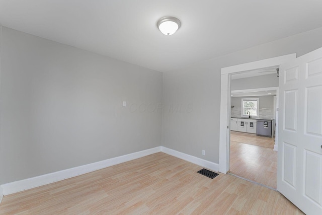 901 Campbell Ave, Columbus, OH 43223 - empty room with light wood-type flooring, baseboards, and a sink