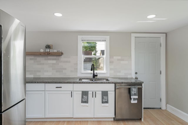 901 Campbell Ave, Columbus, OH 43223 - kitchen with appliances with stainless steel finishes, a sink, open shelves, white cabinetry, and decorative backsplash
