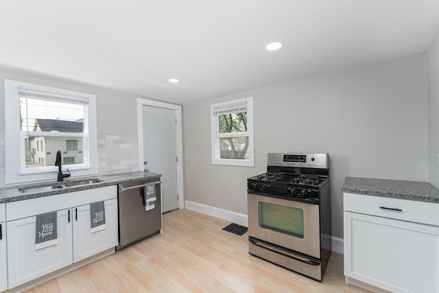 901 Campbell Ave, Columbus, OH 43223 - kitchen featuring stainless steel appliances, a sink, stone countertops, baseboards, and recessed lighting