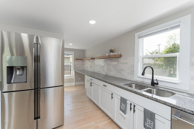 901 Campbell Ave, Columbus, OH 43223 - kitchen with stainless steel appliances, a sink, light stone countertops, white cabinets, and light wood-type flooring