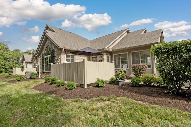 7742 Blue Juniper Dr, Westerville, OH 43082 - view of side of property featuring stone siding and roof with shingles