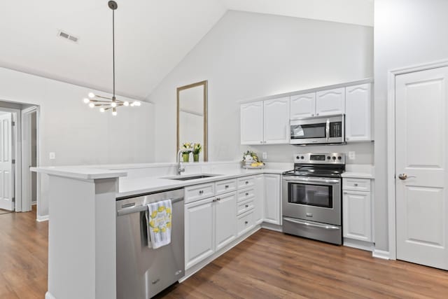 7742 Blue Juniper Dr, Westerville, OH 43082 - kitchen with stainless steel appliances, a sink, a peninsula, white cabinets, and light countertops