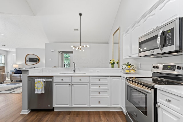 7742 Blue Juniper Dr, Westerville, OH 43082 - kitchen with appliances with stainless steel finishes, a sink, a peninsula, open floor plan, and plenty of natural light