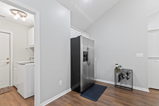 7742 Blue Juniper Dr, Westerville, OH 43082 - clothes washing area with a textured ceiling, cabinet space, wood finished floors, baseboards, and washer and dryer