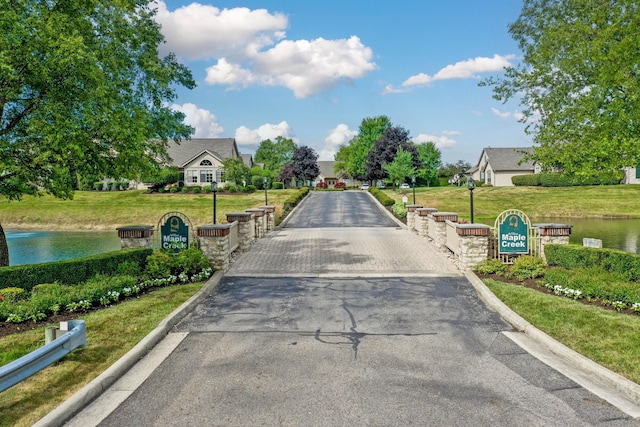 7742 Blue Juniper Dr, Westerville, OH 43082 - view of asphalt road featuring curbs and a water view