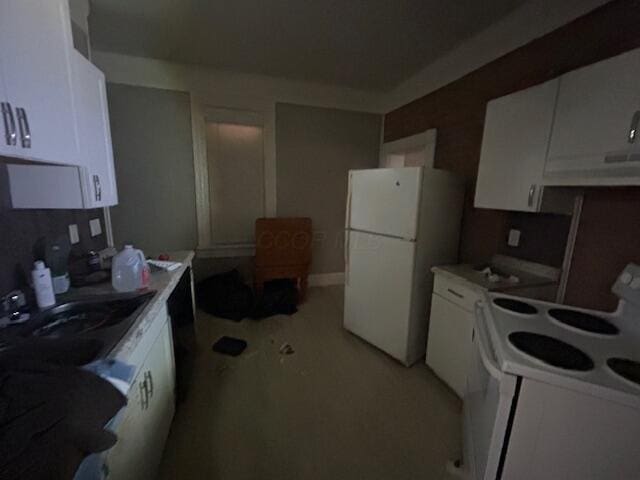kitchen with white appliances, light countertops, and white cabinets