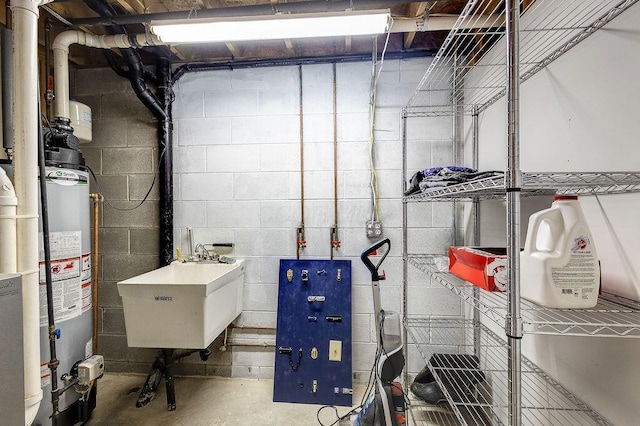 interior space featuring gas water heater and a sink