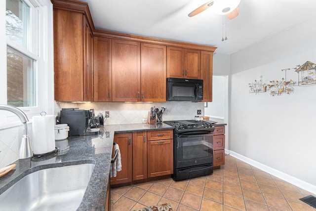 2842 Powell Ave, Columbus, OH 43209 - kitchen featuring black appliances, a sink, backsplash, brown cabinets, and light tile patterned floors