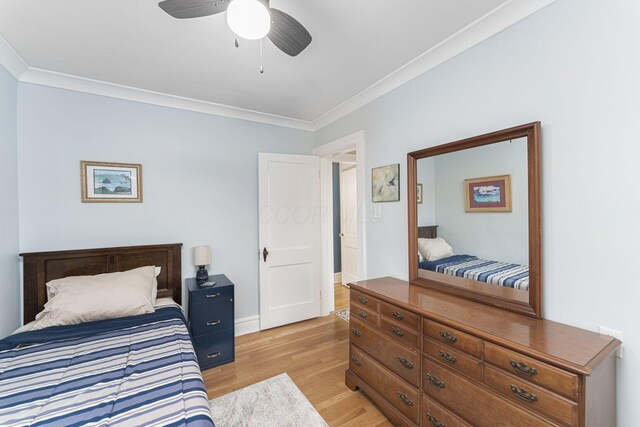 2842 Powell Ave, Columbus, OH 43209 - bedroom with ornamental molding, light wood finished floors, a ceiling fan, and baseboards
