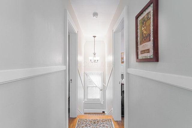 2842 Powell Ave, Columbus, OH 43209 - doorway with a chandelier, light wood-style floors, and baseboards