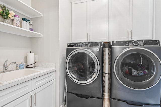 laundry area with cabinet space and separate washer and dryer