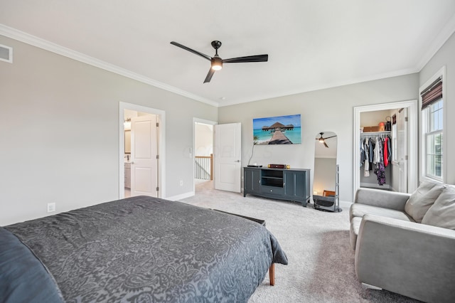 bedroom with crown molding, carpet flooring, baseboards, a walk in closet, and ceiling fan