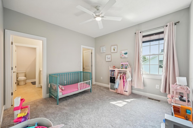carpeted bedroom with baseboards, a ceiling fan, and ensuite bathroom