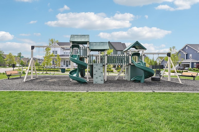 communal playground featuring a yard and a residential view