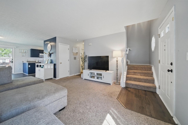 4097 Garrard Dr, Obetz, OH 43207 - living room with baseboards, stairway, and carpet floors
