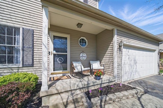 4097 Garrard Dr, Obetz, OH 43207 - entrance to property featuring a porch, a garage, and driveway