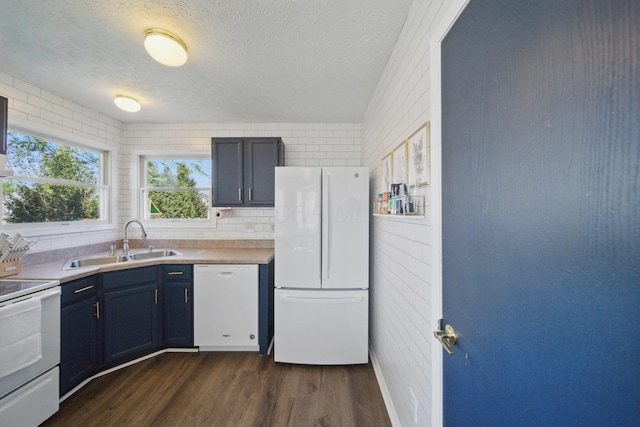 4097 Garrard Dr, Obetz, OH 43207 - kitchen featuring white appliances, a sink, dark wood-style floors, a textured ceiling, and light countertops