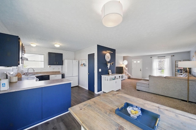 4097 Garrard Dr, Obetz, OH 43207 - kitchen featuring white appliances, a peninsula, a textured ceiling, light countertops, and dark wood-type flooring