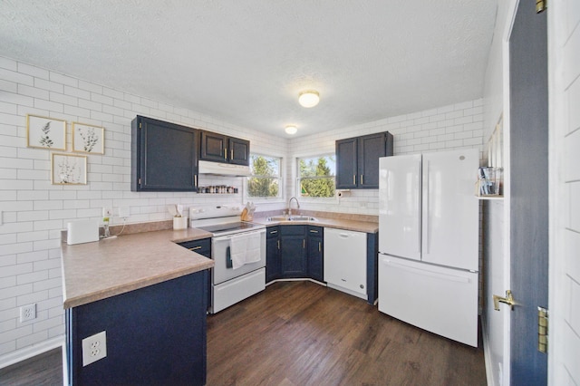 4097 Garrard Dr, Obetz, OH 43207 - kitchen featuring white appliances, a sink, a textured ceiling, dark wood-style floors, and under cabinet range hood