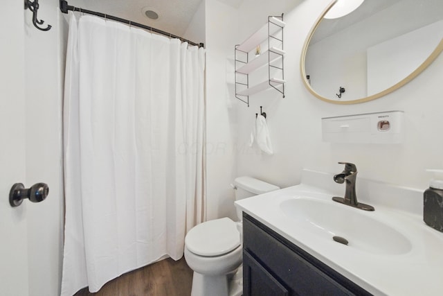 4097 Garrard Dr, Obetz, OH 43207 - full bathroom with toilet, wood finished floors, vanity, and a shower with shower curtain