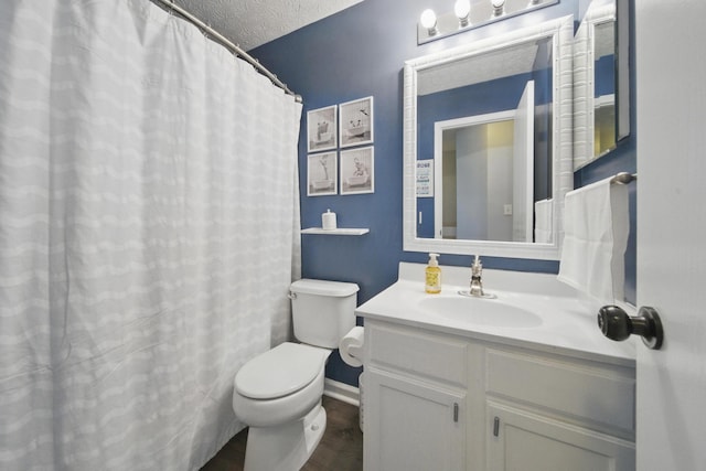 4097 Garrard Dr, Obetz, OH 43207 - bathroom featuring toilet, vanity, baseboards, wood finished floors, and a textured ceiling