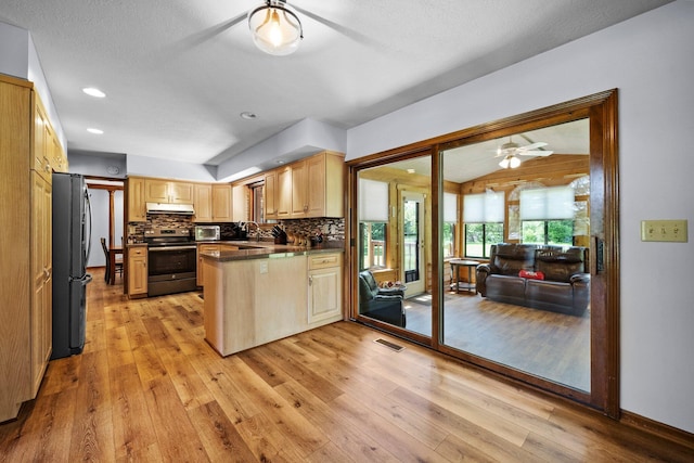 6730 Tussic Rd, Westerville, OH 43082 - kitchen with electric range, a ceiling fan, a peninsula, freestanding refrigerator, and light wood-style floors