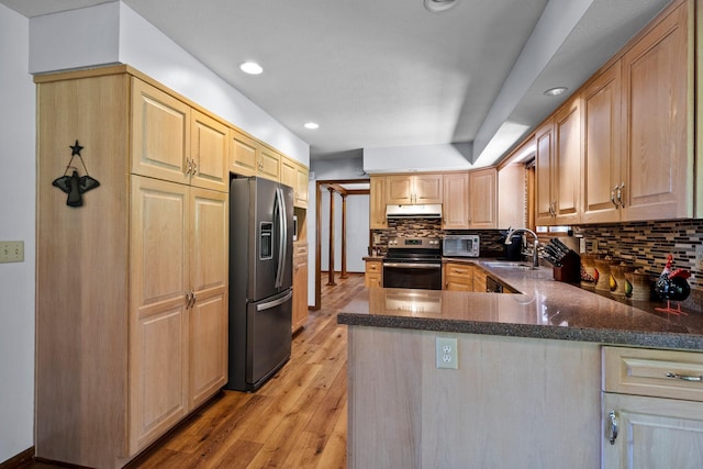 6730 Tussic Rd, Westerville, OH 43082 - kitchen with stainless steel appliances, a sink, light wood-type flooring, decorative backsplash, and light brown cabinets