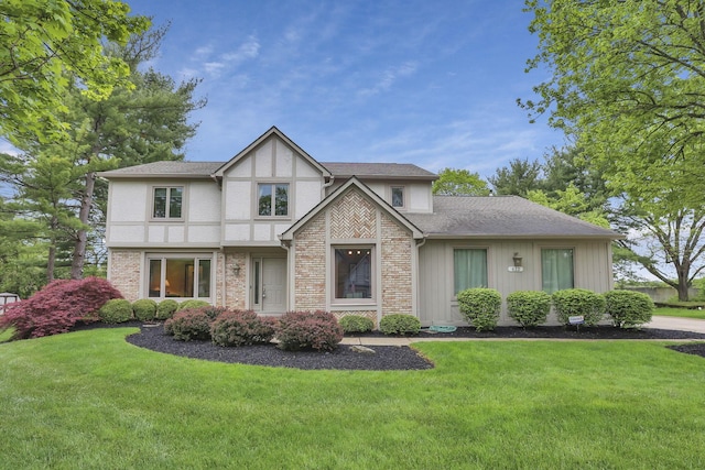 tudor-style house with a front lawn and brick siding