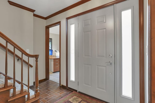 foyer featuring baseboards, stairway, and crown molding