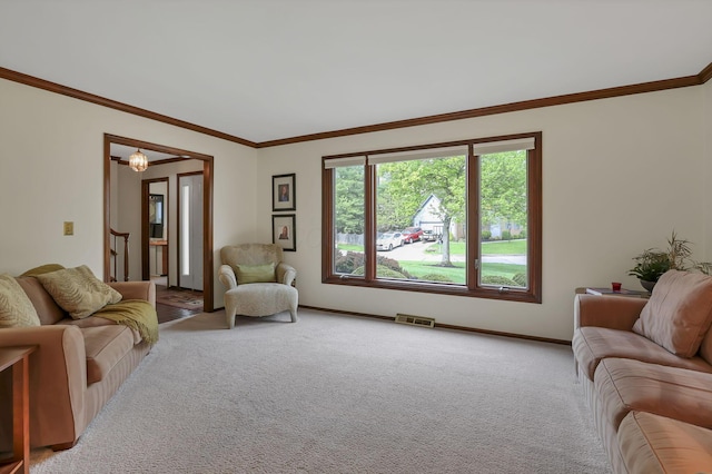 living area with carpet flooring, visible vents, baseboards, and ornamental molding