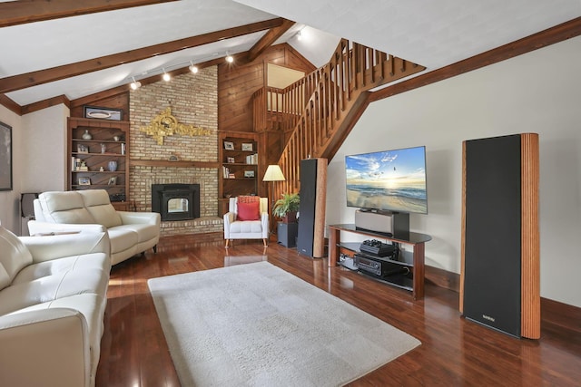 living area featuring wood finished floors, a brick fireplace, stairway, baseboards, and beamed ceiling