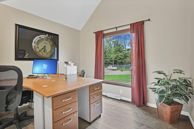 home office with baseboards, visible vents, wood finished floors, and lofted ceiling