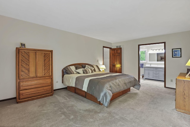 bedroom featuring baseboards, ensuite bathroom, visible vents, and carpet floors