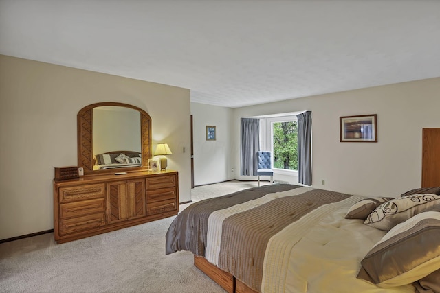 carpeted bedroom featuring baseboards
