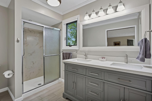 bathroom with double vanity, a stall shower, and a sink
