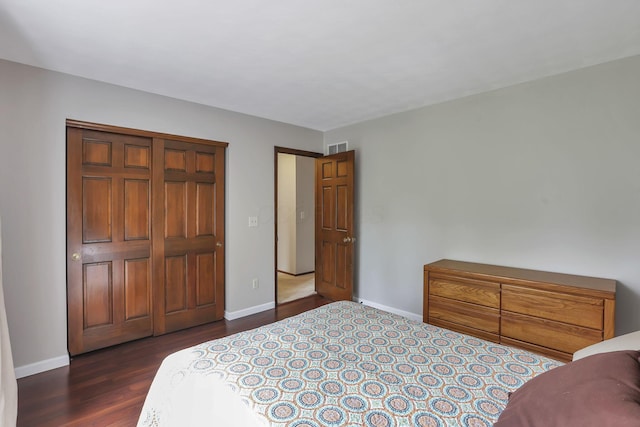 bedroom with visible vents, dark wood-style flooring, and baseboards