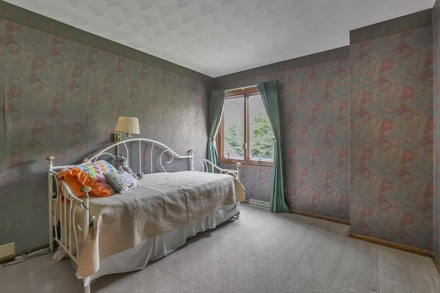 carpeted bedroom featuring wallpapered walls and baseboards