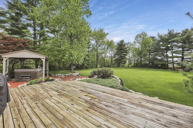 deck with a lawn, a gazebo, and a hot tub