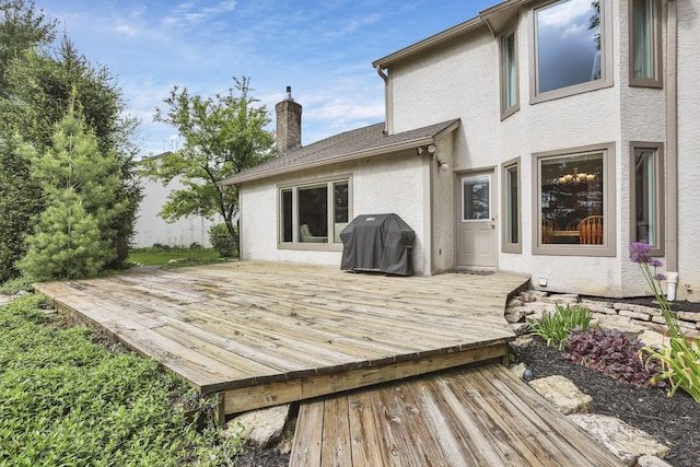 wooden deck featuring area for grilling