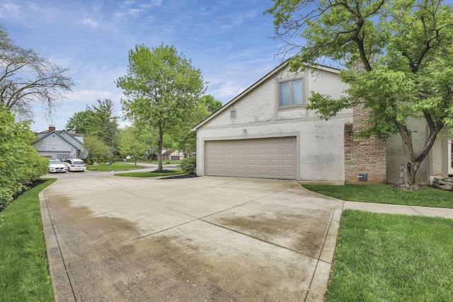 view of side of home featuring an attached garage, stucco siding, a lawn, brick siding, and driveway