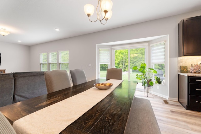 dining area featuring light wood finished floors, recessed lighting, a chandelier, and baseboards