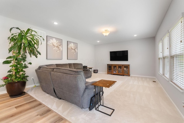 living room featuring baseboards and recessed lighting