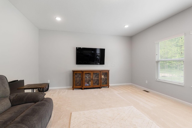 living area with light carpet, baseboards, and recessed lighting