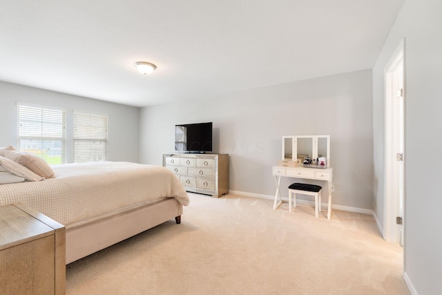 bedroom featuring light carpet and baseboards