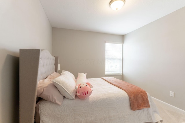 carpeted bedroom with baseboards