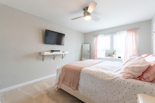 bedroom featuring light colored carpet, baseboards, and ceiling fan