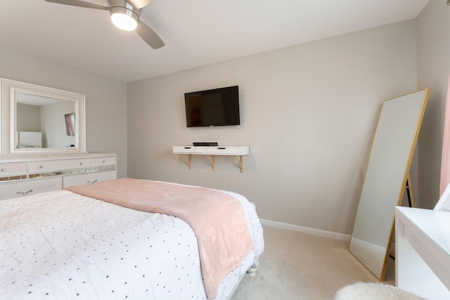 bedroom with light carpet, baseboards, and a ceiling fan