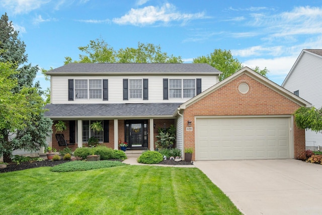 670 Mill Wood Blvd, Marysville, OH 43040 - traditional home with concrete driveway, a garage, brick siding, a front lawn, and covered porch