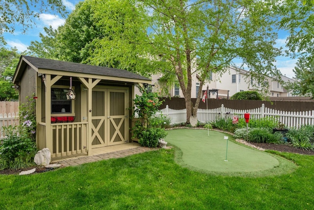 670 Mill Wood Blvd, Marysville, OH 43040 - view of yard featuring a putting green, a storage shed, fence, and an outdoor structure