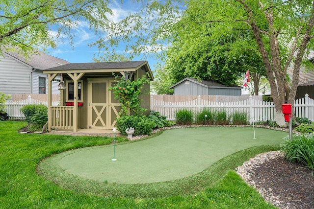 670 Mill Wood Blvd, Marysville, OH 43040 - fenced backyard with a putting green, a shed, and an outdoor structure
